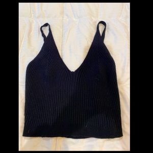 Black crop top with string strap.
